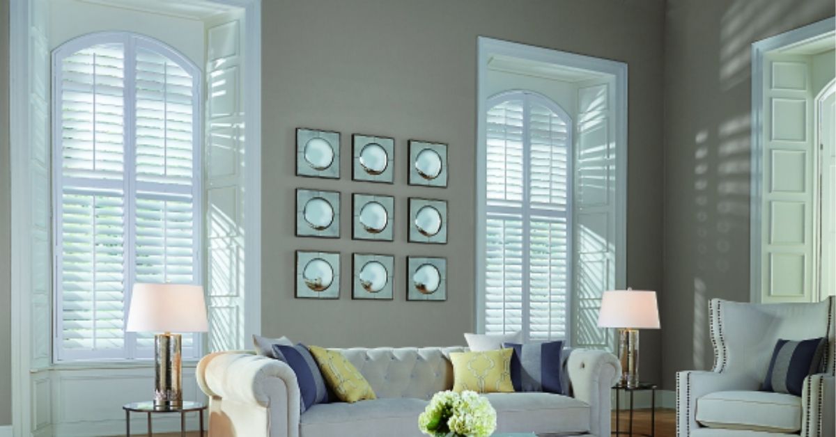 custom-made plantation shutters accentuating a distinctive window design in the living room