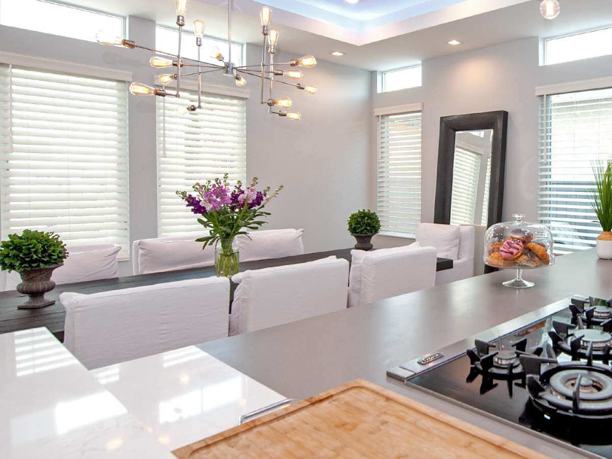 Faux wood blinds are a top choice for dining rooms, offering the look of natural wood with added durability.